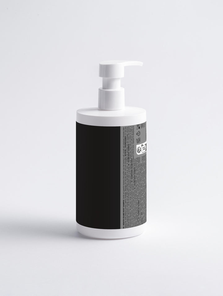 White soap dispenser with black textured label on a light gray background